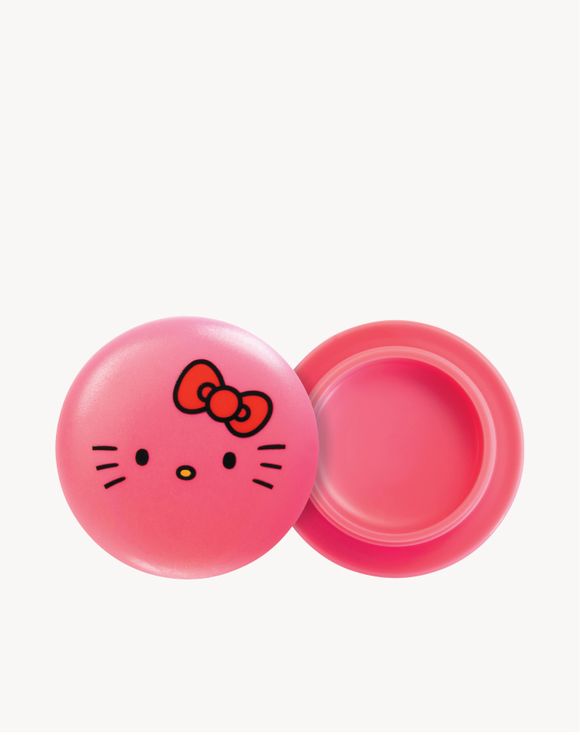 Model smiling with moisturized lips after applying Hello Kitty lip balm