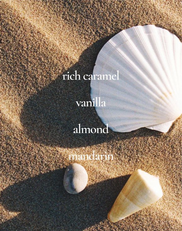 Scent notes: rich caramel, vanilla, almond, mandarin on sandy beach with seashells