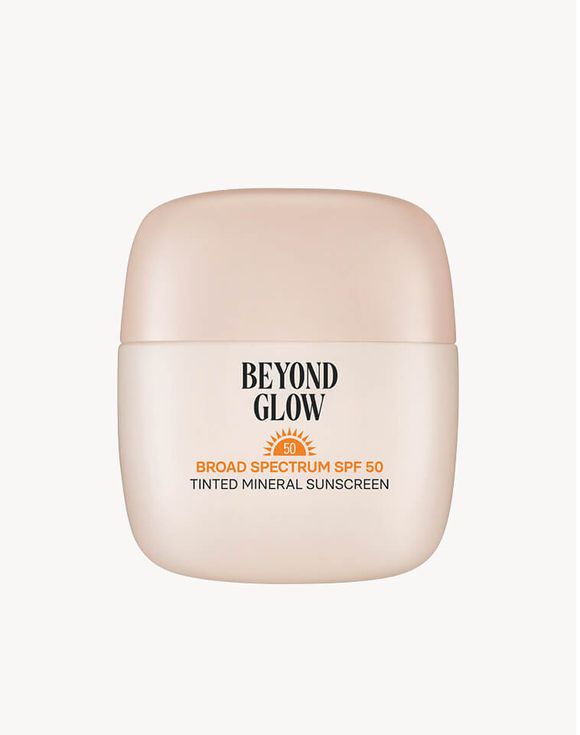 Beyond Glow Tinted Mineral Sunscreen SPF 50 bottle in sand with pool float