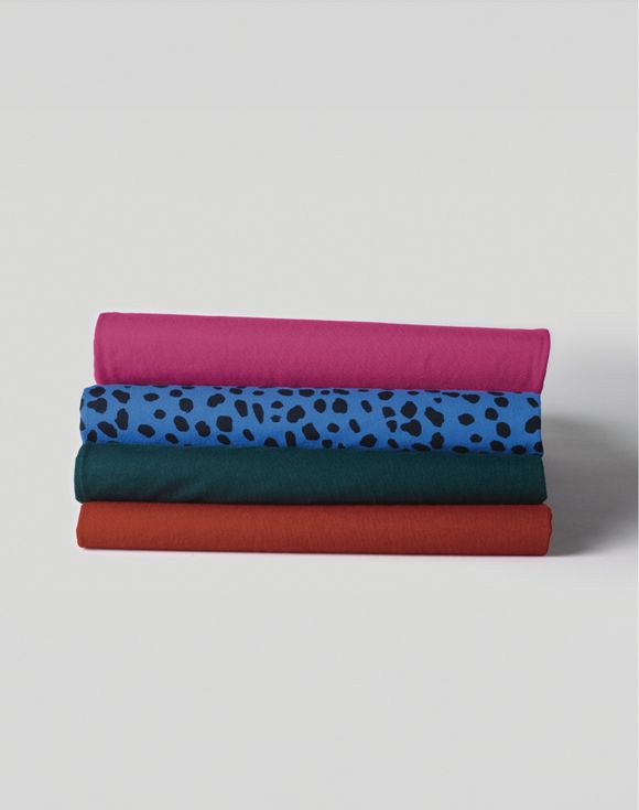Holiday 4-Pack of Tees all four colors fanned out on model