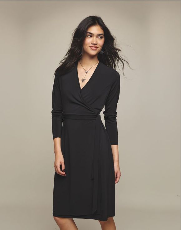 Wrap Dress – model wearing black wrap dress, angled front view with star necklace