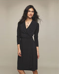 Wrap Dress – model wearing black wrap dress, angled front view with star necklace