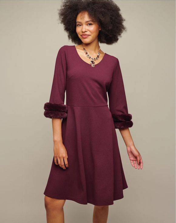 Faux-Fur-Trim Dress - model wearing burgundy dress showing V-neckline and faux-fur cuffs
