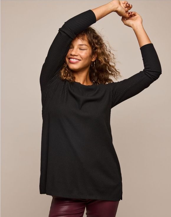 Rib-Knit Tunic - model wearing black tunic looking down