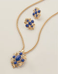 Royal Blue Crown Statement Earrings close-up showing ornate gold-tone scroll setting with royal blue cabochon stones