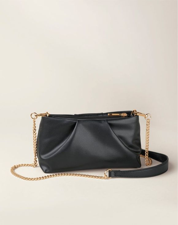 Date Night Bag - model carrying black crossbody bag with gold chain
