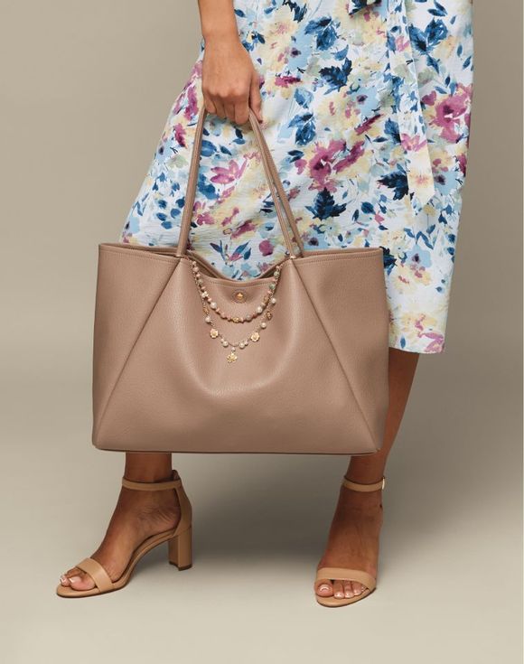 Soft Tote Bag – model carrying bag with floral dress and heeled sandals