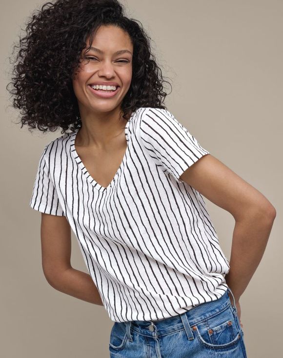 Four-Pack V-Neck Tees model wearing white stripe tee smiling
