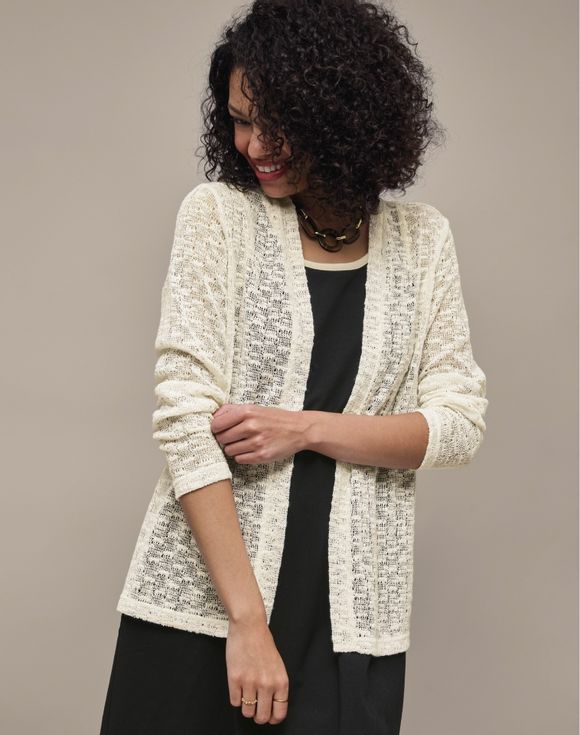Knit Cardigan - model wearing cream open-weave cardigan over black outfit, front view
