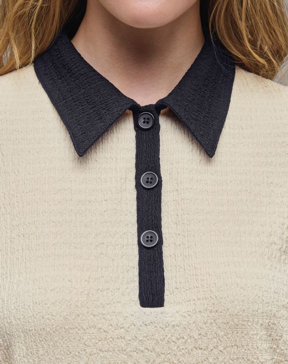 Two-Tone Top - flat lay product shot showing full top with navy trim details