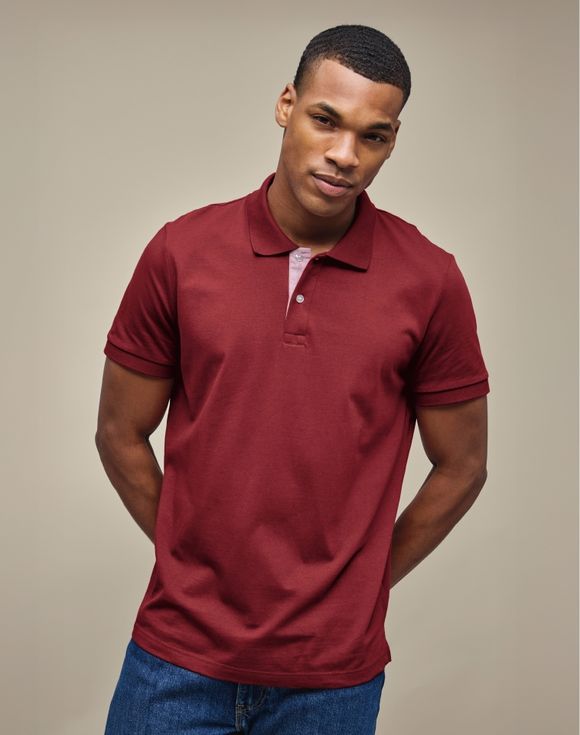 Men's Polo Shirt - burgundy red, model wearing polo with jeans and beaded bracelet