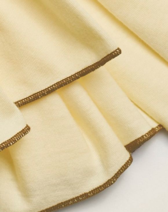 Two-Pack Knit Scarves - close-up of gold overlock stitching detail on cream scarf