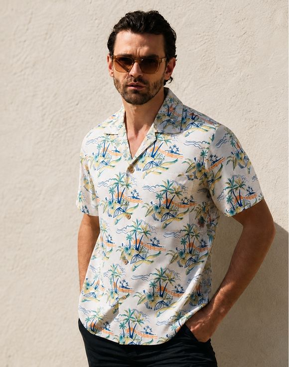 Men's Printed Button Down Shirt - blue floral print, model at beach with ocean background